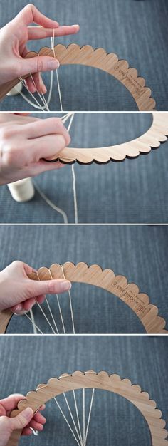 the hands are working on an object made out of wood and string, which is being held