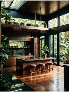 an open kitchen with wooden floors and lots of plants on the counter top, along with bar stools