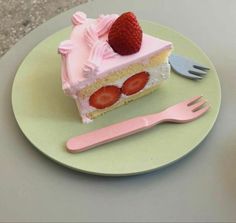 a piece of cake with strawberries on top and a fork sitting next to it