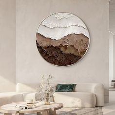 a living room filled with furniture and a large round painting on the wall above it