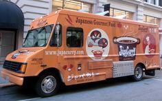 an orange japanese gourmet food truck is parked on the side of the street