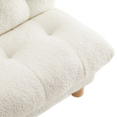 a close up of a white couch cushion on a wooden frame with no buttons or arms