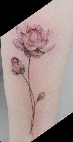 a woman's thigh with a flower tattoo on it