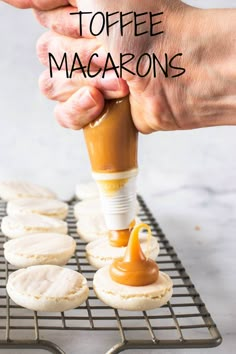 a person is spreading caramel on top of macarons