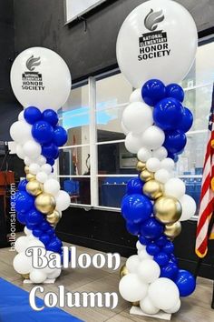 balloon columns are decorated with white and blue balloons