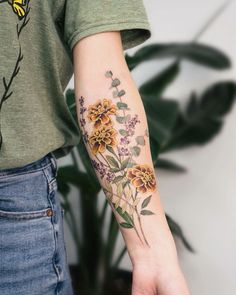 a person with a flower tattoo on their arm