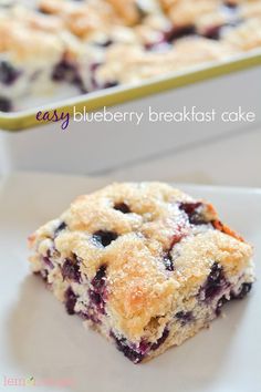 blueberry breakfast cake on a plate with the rest of the tray in the background