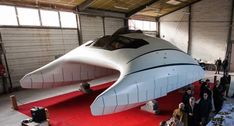 people are standing in front of a large white airplane that is on display at an event