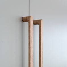 two wooden handles hang on the wall