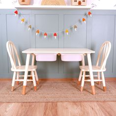 two wooden chairs and a table in a room