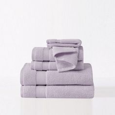 a stack of lavender towels folded on top of each other