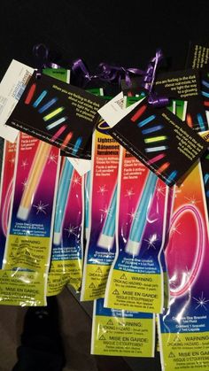 several bags of toothbrushes are lined up on a table with tags attached to them