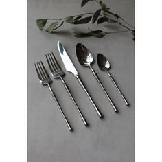 four forks, two spoons and one knife on a table