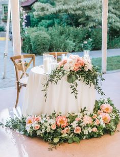 a table with flowers and candles on it