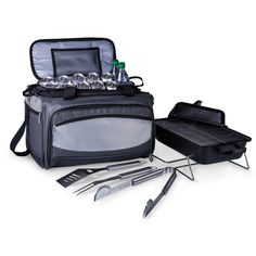 an open grilling bag with utensils and other items in it on a white background