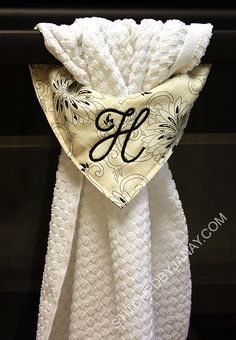 the monogrammed towel is hanging on the wall next to an oven door handle