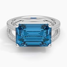 Revelry London Blue Topaz and Diamond Cocktail Ring - Platinum. A dramatic emerald-cut London blue topaz takes center stage in a unique split shank design adorned with shimmering diamonds in this modern cocktail ring. As festive as it is contemporary, this romantic hues-of-blue design is sure to catch the light and the eye (2/5 total carat weight). Modern Cocktail, Diamond Cocktail Ring, Right Hand Rings, Diamond Cocktail Rings, Detailed Ring, Split Shank, London Blue Topaz, Blue Topaz Ring, London Blue