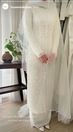 a woman wearing a white dress and veil