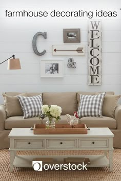 a living room filled with furniture and pictures on the wall next to a coffee table