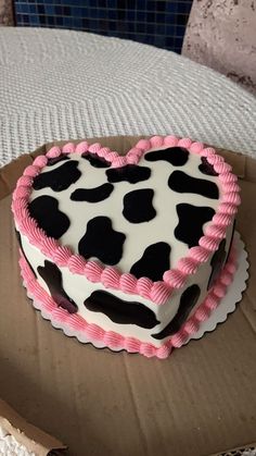 a heart shaped cake sitting on top of a cardboard box