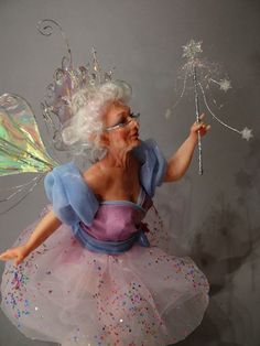 a woman dressed as a fairy holding a sparkle wand