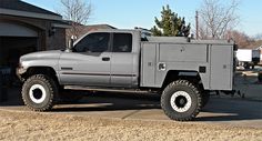 a large gray truck parked in front of a house