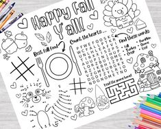 the happy fall day coloring page is next to colored pencils and crayons