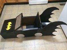 a cardboard box shaped like a batmobile