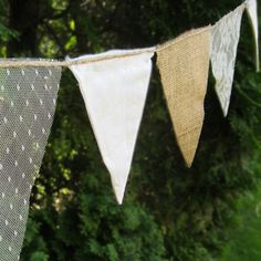 three bunting flags are hanging in front of some trees