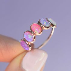 -14kt rose gold vermeil -6x4mm oval cut opal ombre stones, bezel set A striking rose gold band with the perfect opal ombre color way of stones. The gorgeous pink hues and bright colors in this ring will put a smile on your face - guaranteed. To extend the life of your gold plated and vermeil jewelry, avoid wearing when washing hands, showering, applying lotion, using harsh cleaning supplies or working out. To clean, buff gently with a soft and dry 100% cotton cloth or a microfiber cloth. Do not Pink Opal Jewelry, Bijoux Art Nouveau, Crystal Altar, Fun Outfits, Online Closet, Dope Jewelry, Lia Sophia, Rose Gold Band, Vermeil Jewelry