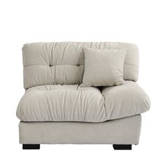 a white couch with two pillows on the back and one arm folded up to it's side