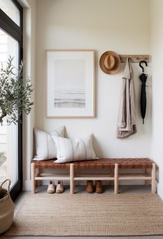 a bench and coat rack in a room