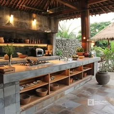 an outdoor kitchen with stone counter tops and shelves