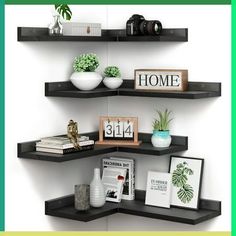 three black shelves with books, plants and pictures on them