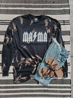 "Acid washed MAMA long-sleeve! -\"Unisex\" So they fit both men and women comfortably. Black Long Sleeve For size reference, photo above is a size medium. PLEASE KEEP IN MIND - No two shirts will come out the exact same. The design pattern will be the same, but the exact placements of the bleached areas, also the intensity of the colors, will all vary shirt to shirt" Washed Black Long Sleeve Top With Letter Print, Acid Wash Long Sleeve Soft-washed Tops, Acid Wash Soft-washed Long Sleeve Tops, Acid Wash Long Sleeve Tops, Acid Wash Long Sleeve Tops For Fall, Casual Long Sleeve Tops For Festival, Faded Stonewashed Long Sleeve Tops, Washed Black Long Sleeve Grunge Top, Stonewashed Long Sleeve Tops For Fall