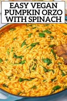 an easy vegan pumpkin orzo with spinach in a blue skillet and wooden spoon