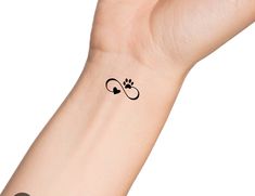 a person's arm with a small tattoo on the left side of their wrist