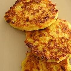 three pancakes sitting on top of a white plate