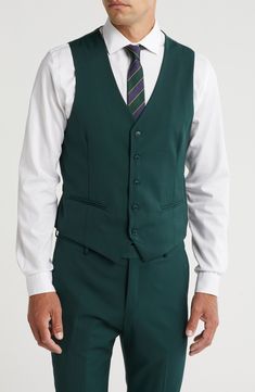 Stretch construction and a skinny cut mean modern appeal from a head-turning three-piece suit. Jacket has notched lapels; chest welt pocket; front welt pockets Vest has front button closure; V-neck Pants have zip fly with button closure; front slant pockets; back button-welt pockets Jacket and vest are lined; trousers are lined to the knee 62% polyester, 35% viscose, 3% spandex Dry clean Imported Each suit has a 6” drop, meaning that a size 38R jacket is paired with size 32 pants Tailored Green Single Button Suits, Green Slim Fit Business Blazer, Fitted Solid Suits For Work, Fitted Notched Suit For Workwear, Semi-formal Single-breasted Green Three-piece Suit, Green Slim Fit Blazer With Notch Lapel, Tailored Three-piece Suit With Pockets For Office, Business Vest With Notch Lapel And Pockets, Fitted Three-piece Suit With Welt Pockets For Office