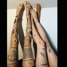 three people with matching tattoos on their legs