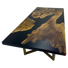 a black table with gold leaf design on it