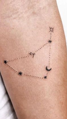 a woman's lower arm with stars and the moon on it