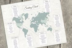 the seating chart for a wedding is displayed on a wooden table with an old world map