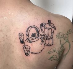 a man's back with a drawing of a kettle and cups on it