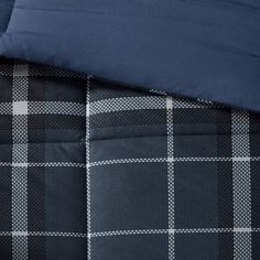 the comforter is made up with blue and white plaid