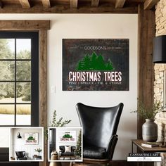 a living room filled with furniture and a christmas tree sign on the wall above it