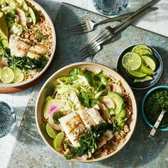 two bowls filled with fish, rice and vegetables