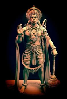 a statue of the hindu god with his hands up in front of him and holding a staff
