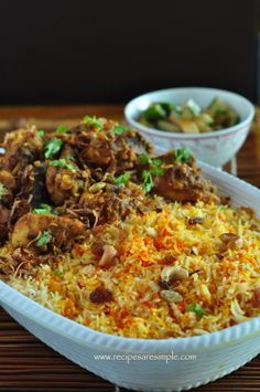 a large white bowl filled with rice and meat