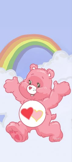 a pink teddy bear holding a heart in front of a rainbow